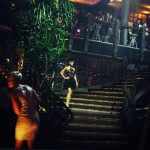 George Wu A model wearing a George Wu dress with a sheer black top and fluffy black skirt descends a staircase.