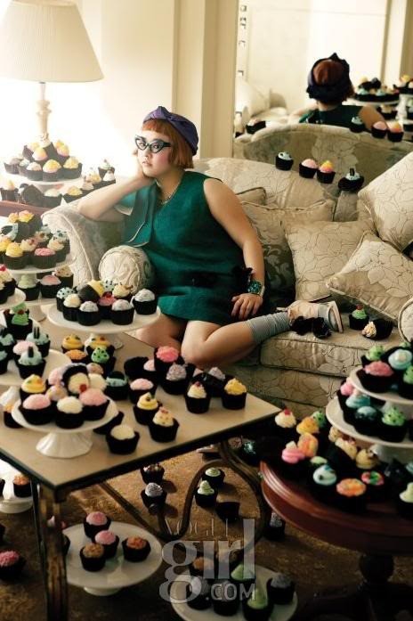 Vogue Korea A young woman sits on a couch, surrounded by hundreds of brightly frosted cupcakes.