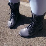 Photo of my grey boots that lace up and come up to my lower calf, I'm also wearing light blue tights.