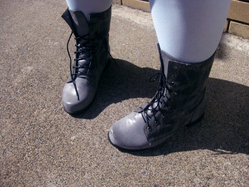 Photo of my grey boots that lace up and come up to my lower calf, I'm also wearing light blue tights.