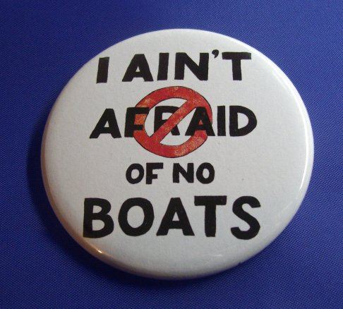 Badge with hand lettering saying "I ain't afraid of no boats". The word "afraid" has a circle with a red line slashing through the letters.