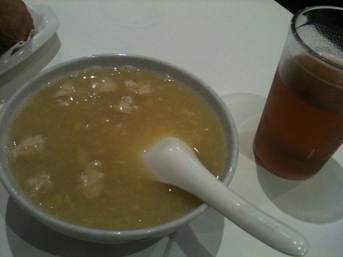 Photo of faux chicken and corn soup with a cup of iced tea.