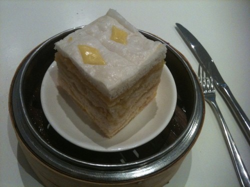 Photo of a cake with lots of layers in a steaming basket. 