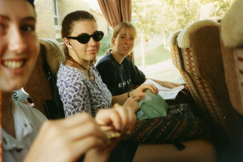 Photo of me and teenage school friends on a bus. I'm listening to a walkman and have sunglasses on.