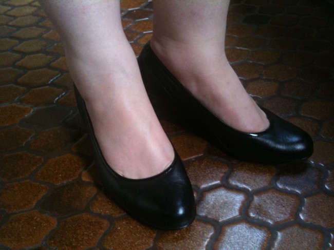 Close up shot of my feet wearing black court style shoes with a low wedge heel. They're a bit shiny!