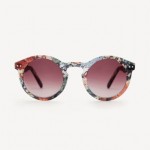 A pair of round sunglasses with floral frames and burgundy graduated frames.