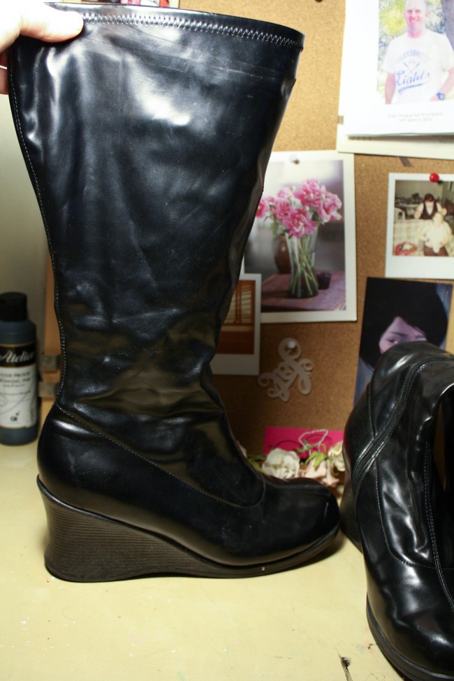 A pair of black PVC boots with a wedge.
