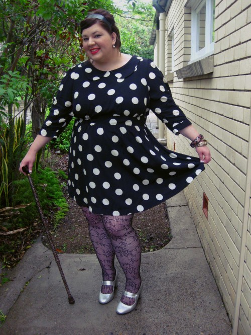 Outfit photo of me in the polka dot dress - I'm holding the hem of the skirt out.