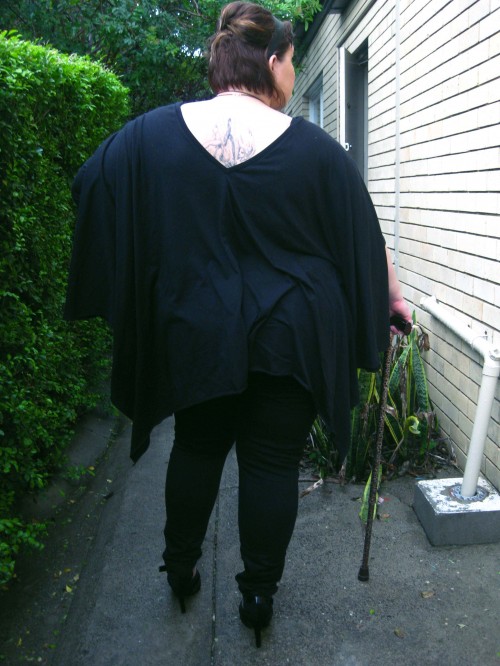 Photo of the back of the outfit with the oversized black top and skinny jeans - the back neckline actually comes into a V! It reveals a little of the tattoo on my upper back, a fairy falling through bubbles.