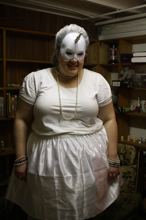 Photo of me wearing all white and a mask with a unicorn horn.