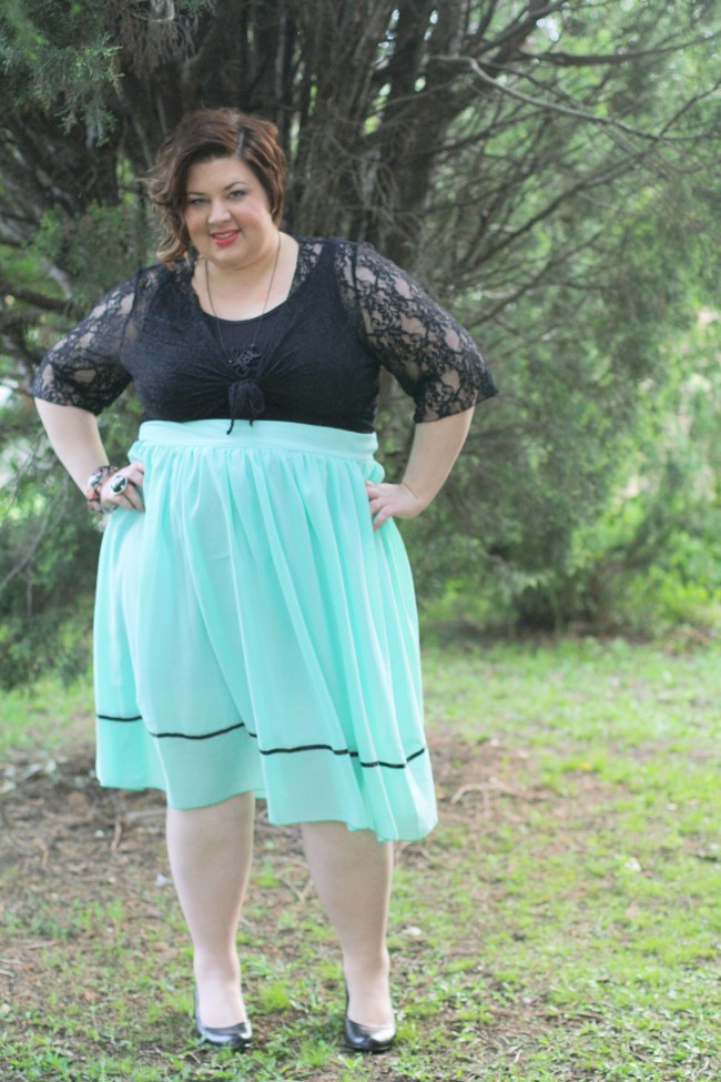 Outfit photo of me in a dress with a black top and full pale blue skirt, and a lace cardi tied under my boobs. My hair is curled and I'm wearing black shoes.