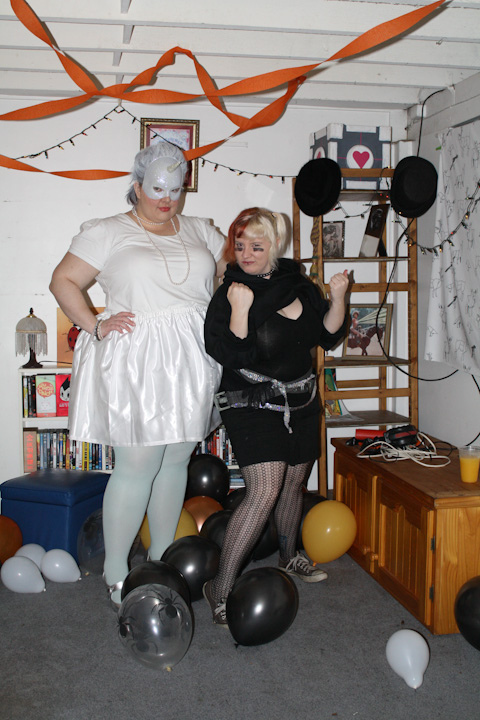 Photo of me (in my unicorn costume) with Heather as Roxie Richter, wearing all black with her hair in pigtails and black stripes under her eyes.