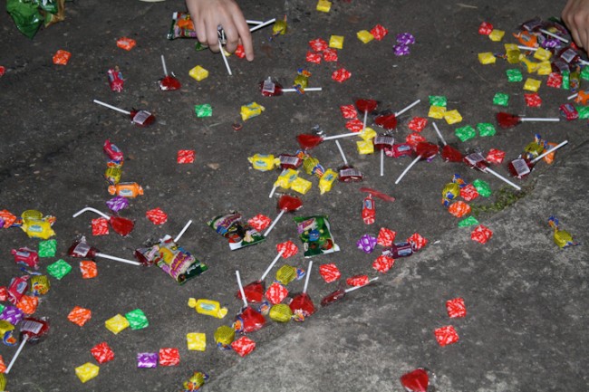 Scattered lollies on the ground from the broken piñata.