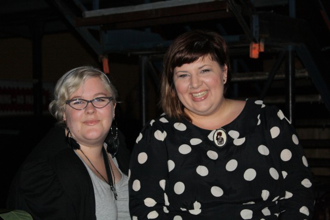 Photo of Zoe and I smiling, Zoe with blonde Veronica Lake styled hair and me with brown hair and an awesome polka dot dress.