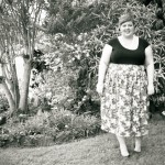 Black and white and slightly blurry photo of me in the garden.