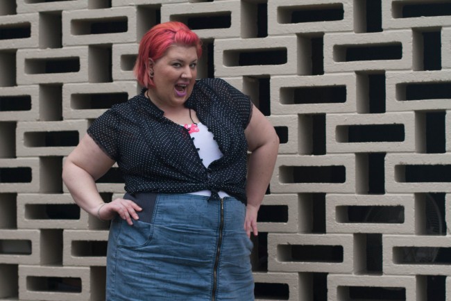 Photo of me in the black polka dot shirt, singlet and skirt - my hands are on my hips and I'm kind of opening my mouth in a facetious FASHUN smile.