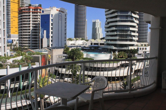 Photo standing on a balcony looking into a bunch of seaside high rise apartments.