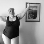 Black and white photo of me wearing a swim suit throwing my arms in the air.