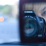 Photo of me looking into a small compact mirror through the camera.