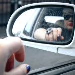 A photo of my reflection in the passenger seat side mirror.