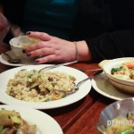 A photo of our dinner spread with my hands in the background busily scooping food out (to go in my face!)