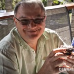 A photo of my dad grinning broadly with a chocolate stack in his hand.