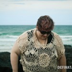 A photo of me looking down, the crochet top I'm wearing is clearer in this photo than the first one and it has a big crochet flower on the front of it.