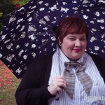 Me, smiling in a doctorly way, under the cover of the navy cat umbrella.