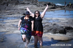 Erin and I standing in the rock pools, I'm kicking water and Erin has her arms outstretched.