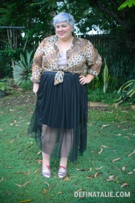 Outfit photo of me, fat white and lilac haired, wearing an animal print shirt tied at my waist with a beige singlet underneath, and a black mesh skirt over a shorter black skirt. Also: GLITTER SHOES.