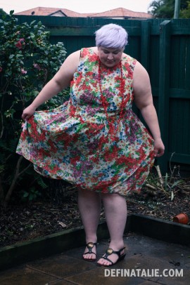 A photo of the front of the dress pulled out to each side.