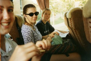 A photo of me circa 1996 at 15, sitting on a bus with some friends trying to be really cool wearing cat eye sunglasses and listening to my Walkman. COOL.