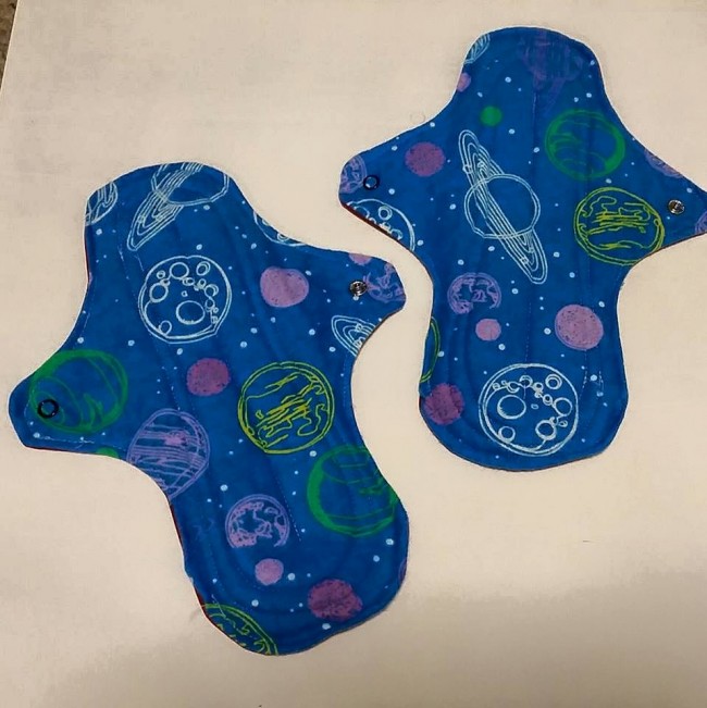 Two of my space print pads - these are an all-in-one style with the core layers sandwiched between flannel (top) and PUL (backing).