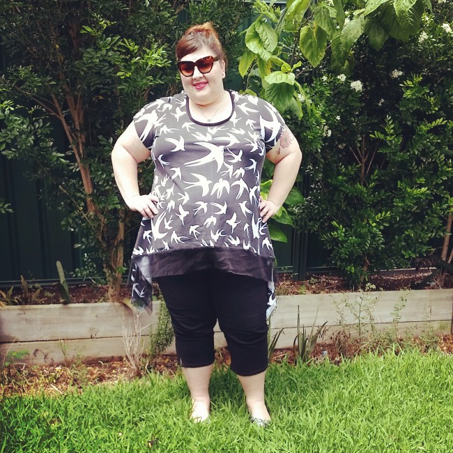 In my backyard (the trees are huge now!) wearing my black and white swallow t-shirt with some black cropped pants.