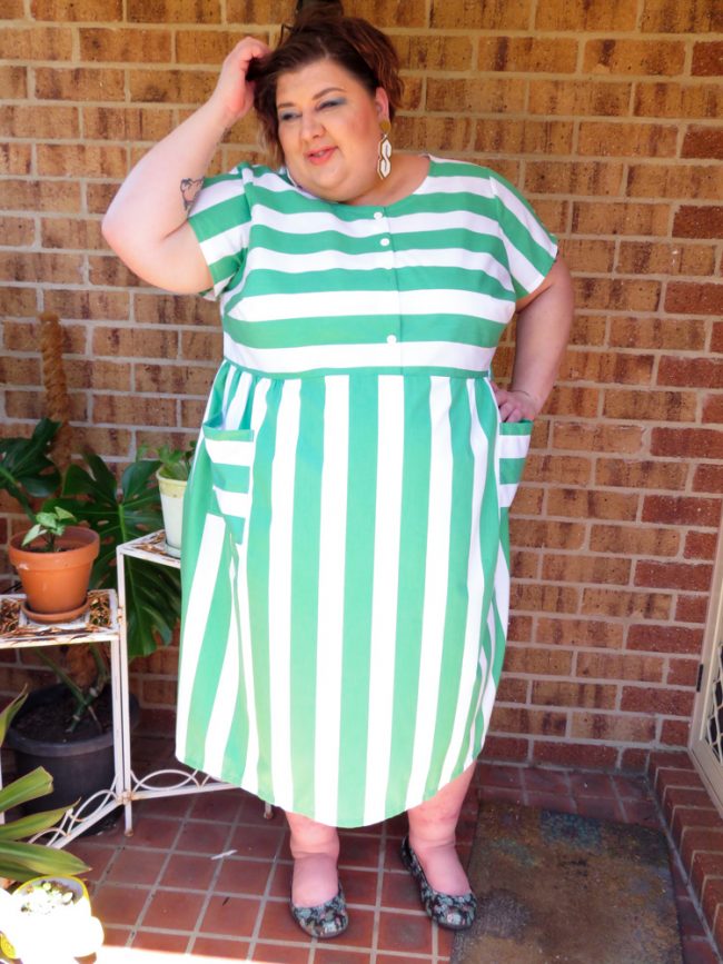 Photo of me wearing my green striped dress, tousling my hair.